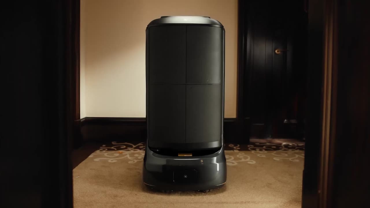 Manufacturer footage (Pudu): a delivery robot waiting outside a guest-room door in a hotel corridor