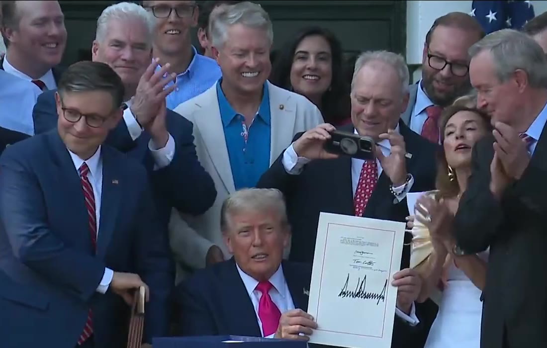 The signed One Big Beautiful Bill Act held up at the White House signing ceremony on July 4, 2025
