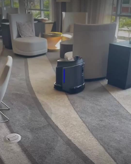 A service robot crossing a hotel lobby